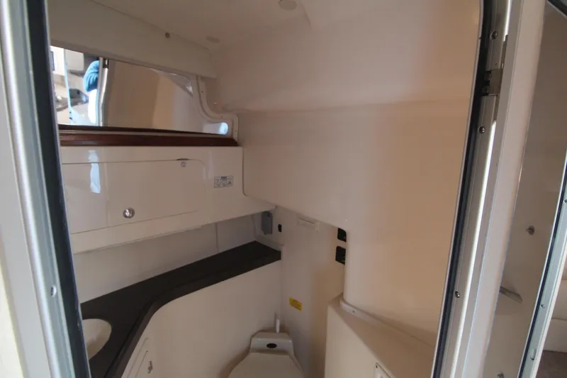Slide: The Image of 2001 Grady-White Express 330 boat interior with compact bathroom and storage. - 36