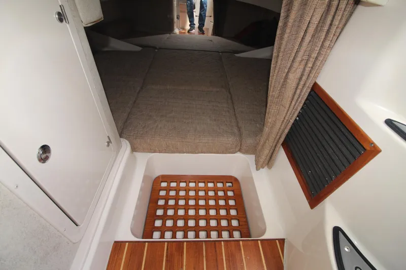 Slide: The Image of 2001 Grady-White Express 330 cabin interior with bed and wooden flooring. - 38