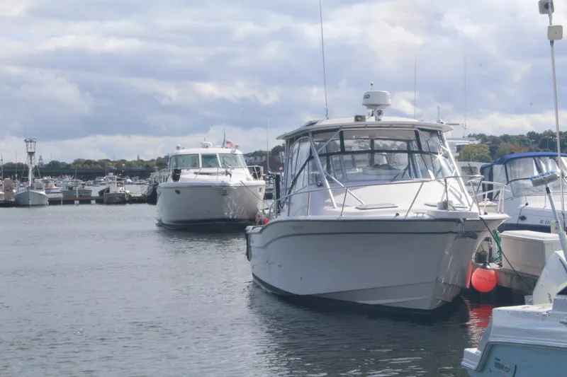 Slide: The Image of 2001 Grady-White Express 330 boat docked in a marina under cloudy skies. - 4