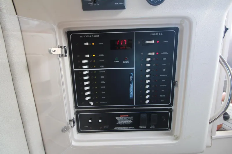 Slide: The Image of Control panel of a 2001 Grady-White Express 330 boat, showing electrical switches and indicators. - 40