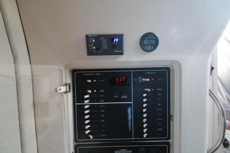 Slide: The Image of Control panel of a 2001 Grady-White Express 330 boat, featuring various switches and displays. - 41