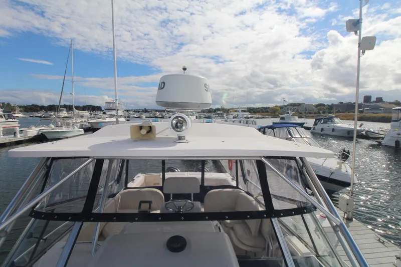 Slide: The Image of 2001 Grady-White Express 330 boat docked in a marina under a partly cloudy sky. - 44