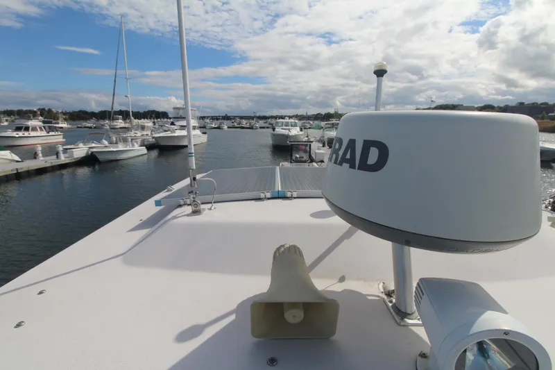 Slide: The Image of 2001 Grady-White Express 330 boat docked in a marina with clear skies. - 45
