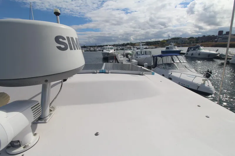 Slide: The Image of 2001 Grady-White Express 330 boat docked in a marina with other vessels. - 46