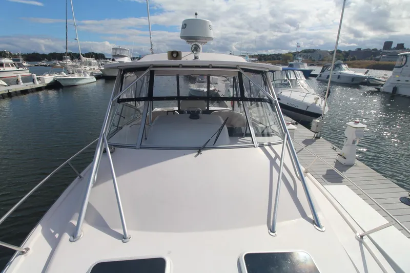Slide: The Image of 2001 Grady-White Express 330 boat docked at marina under cloudy sky. - 47