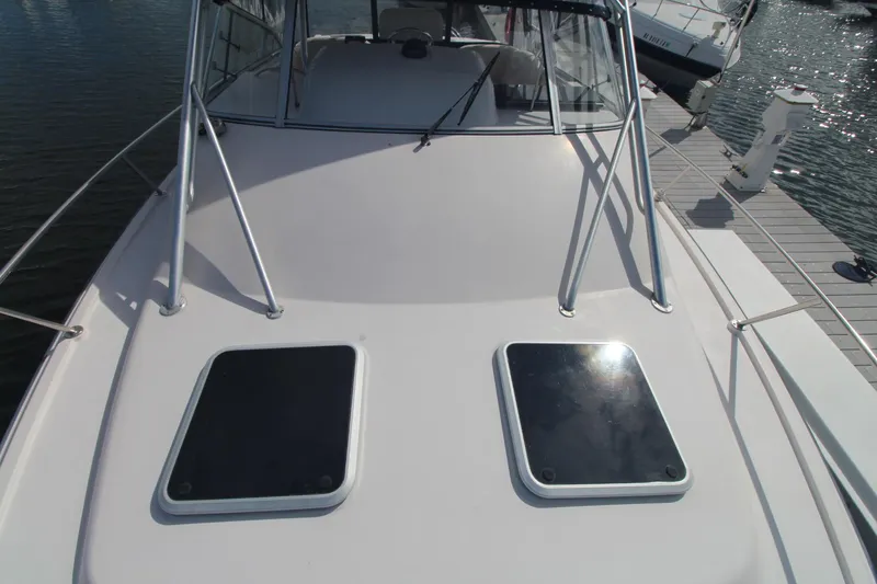 Slide: The Image of 2001 Grady-White Express 330 boat deck with hatches, docked at marina. - 48