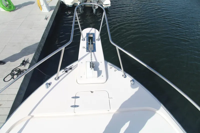 Slide: The Image of Bow view of 2001 Grady-White Express 330 boat docked at marina. - 49