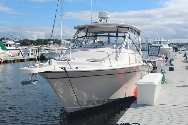 Slide: The Image of 2001 Grady-White Express 330 boat docked at marina under blue sky. - 5