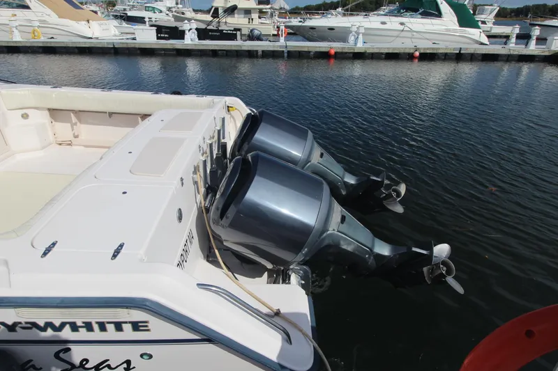 Slide: The Image of 2001 Grady-White Express 330 boat with dual outboard motors docked in marina. - 6