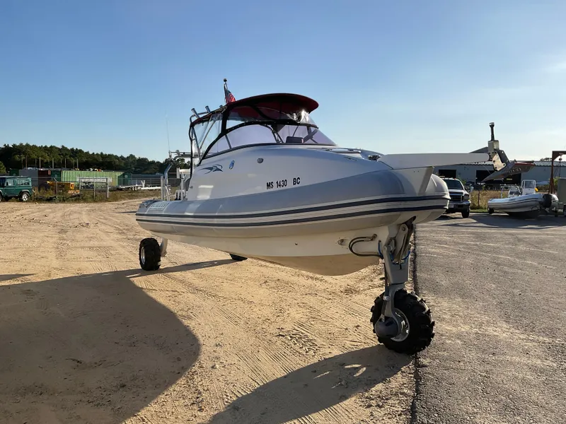 Slide: The Image of 2013 Sealegs 7.7m Cabin boat with wheels on sandy terrain, sunny day. - 1