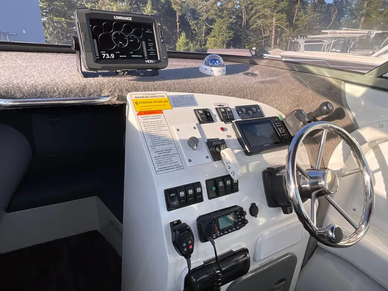 Slide: The Image of Sealegs 7.7m Cabin 2013 boat dashboard with navigation equipment and steering wheel. - 10