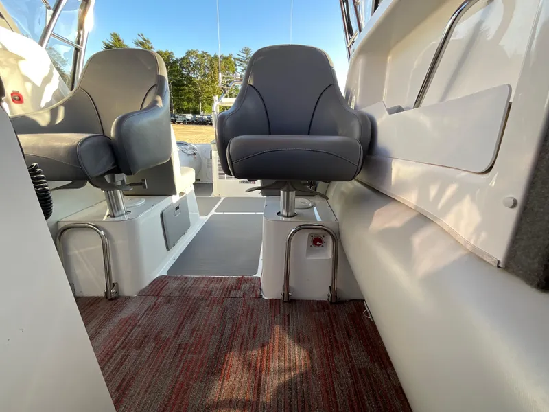 Slide: The Image of Interior of 2013 Sealegs 7.7m Cabin boat with gray seats and red carpet. - 11
