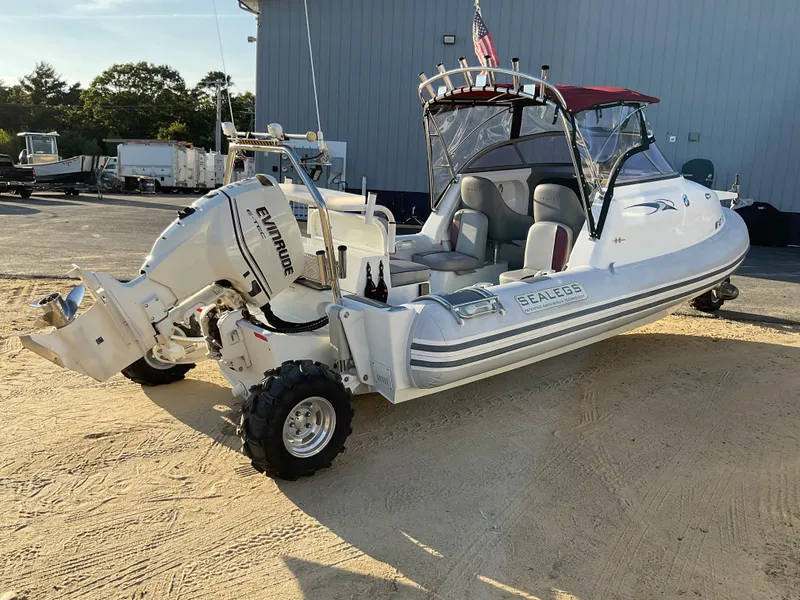 Slide: The Image of 2013 Sealegs 7.7m Cabin boat with Evinrude engine on sandy ground. - 17