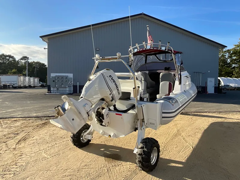 Slide: The Image of 2013 Sealegs 7.7m Cabin boat with wheels, parked on sandy ground. - 4