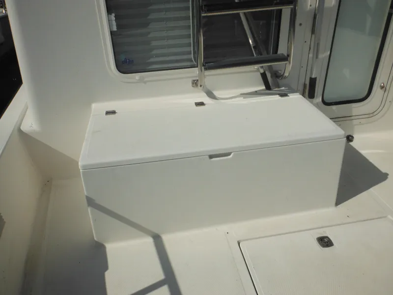 Slide: The Image of Nordic Tug 32 (2005) deck area with storage compartment and ladder. - 14