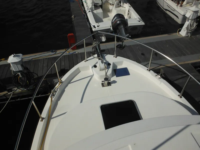 Slide: The Image of Nordic Tug 32 (2005) docked, view from bow, marina setting. - 22