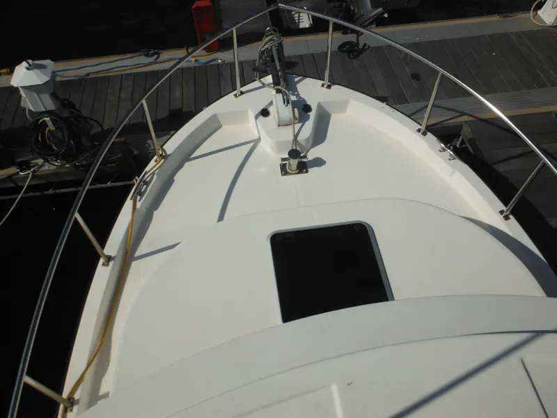 Slide: The Image of Nordic Tug 32 (2005) bow view at dock, featuring deck and railing. - 24