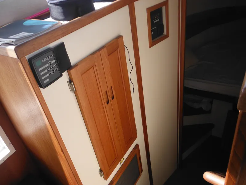 Slide: The Image of Interior of 2005 Nordic Tug 32, featuring wooden cabinetry and control panel. - 31