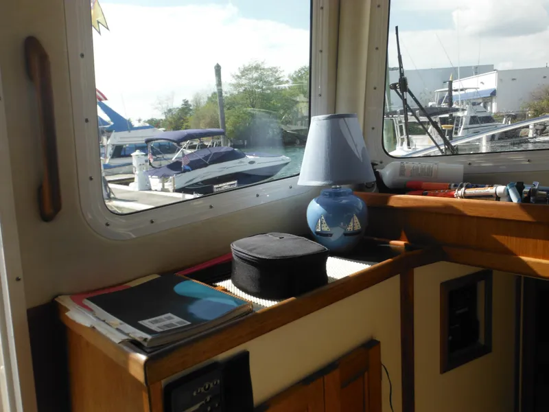 Slide: The Image of Interior of 2005 Nordic Tug 32 with window view of marina. - 32