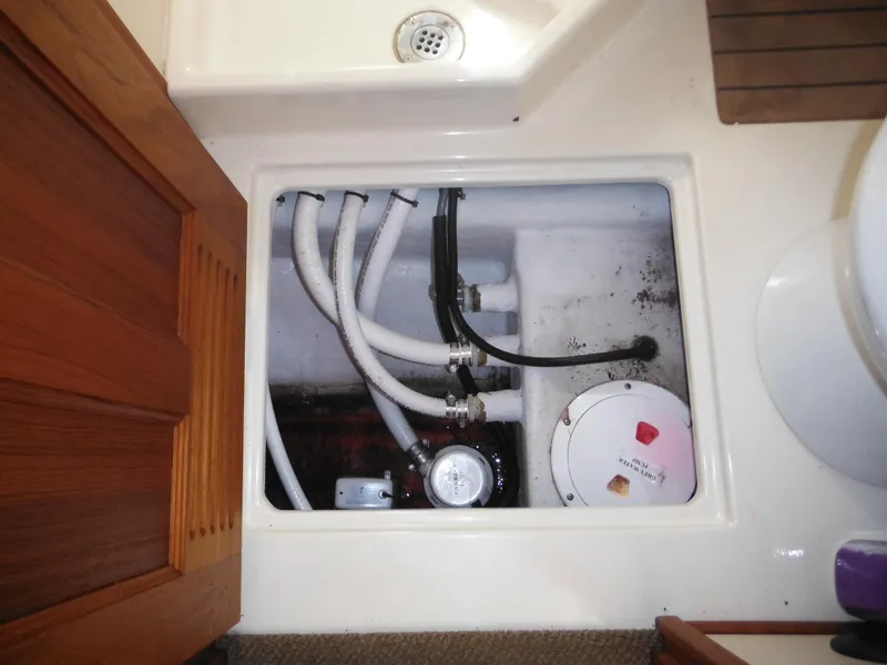 Slide: The Image of Engine compartment of 2005 Nordic Tug 32 with visible hoses and components. - 35