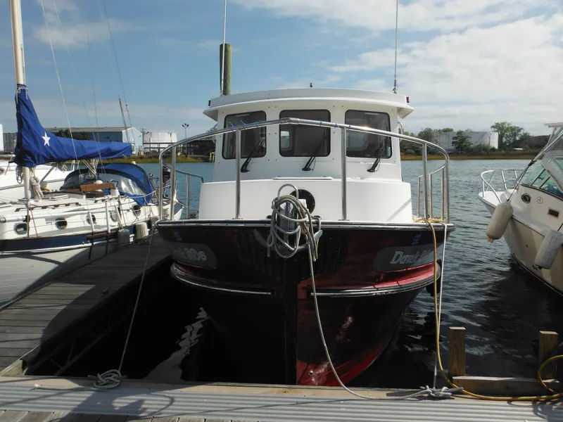 Slide: The Image of 2005 Nordic Tug 32 docked at marina, front view. - 4