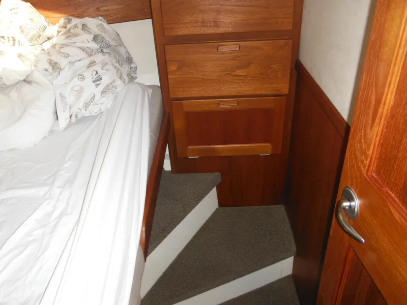 Slide: The Image of Cozy cabin interior of 2005 Nordic Tug 32 with wooden drawers and bed. - 42