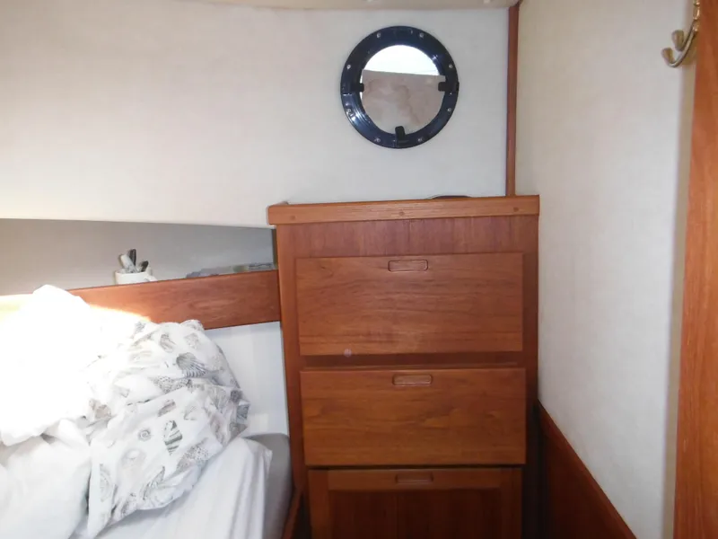 Slide: The Image of Wooden drawers and porthole in 2005 Nordic Tug 32 cabin interior. - 43