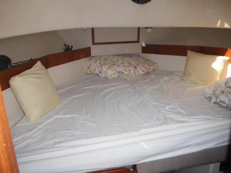 Slide: The Image of Cozy cabin bed in 2005 Nordic Tug 32 boat with pillows and floral bedding. - 44
