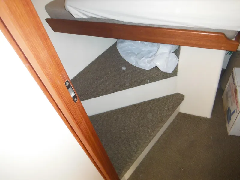 Slide: The Image of Interior stairs of a 2005 Nordic Tug 32 boat with carpeted steps. - 45