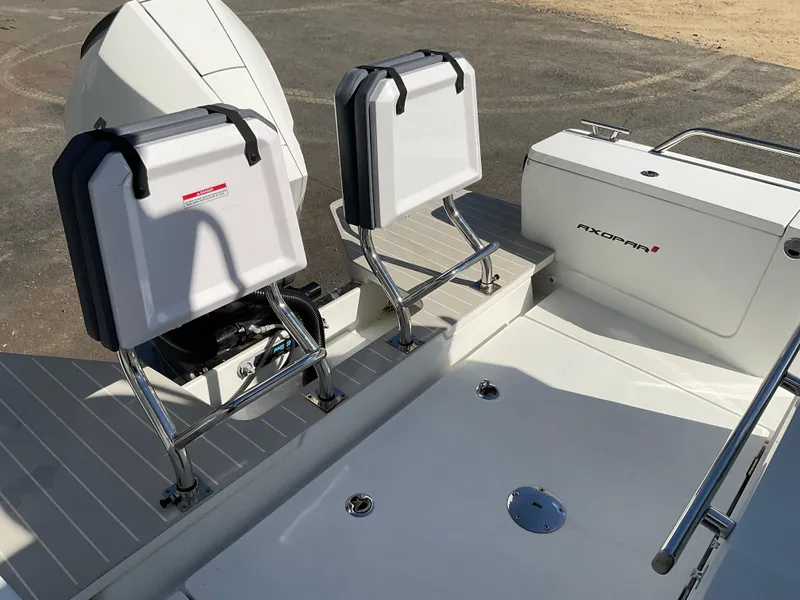 Slide: The Image of 2020 Axopar 28 boat deck with seating and engine, showcasing modern design. - 11