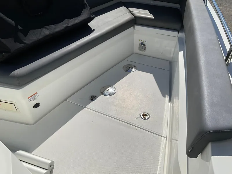 Slide: The Image of 2020 Axopar 28 boat interior with cushioned seating and storage compartments. - 14