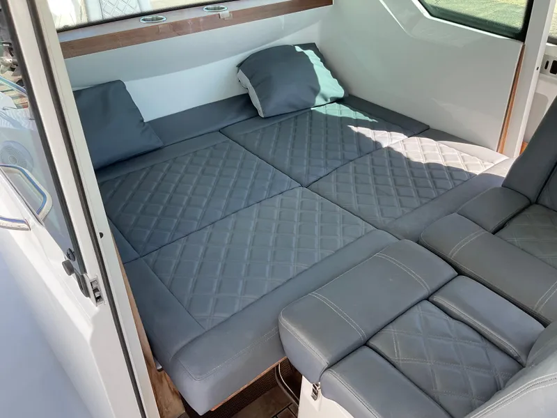 Slide: The Image of Luxurious interior of 2020 Axopar 28 boat with quilted gray seating. - 19
