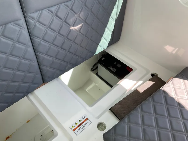 Slide: The Image of Axopar 28 (2020) boat interior with quilted seats and storage compartment. - 20