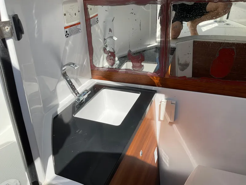 Slide: The Image of 2020 Axopar 28 boat interior with sink and mirror. - 27