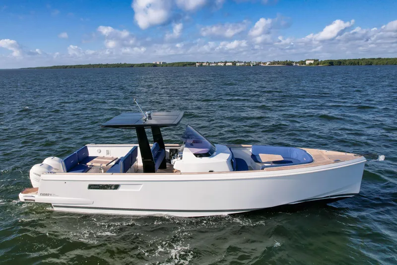 Slide: The Image of 2019 Fjord 38 Xpress boat cruising on open water under a blue sky. - 1