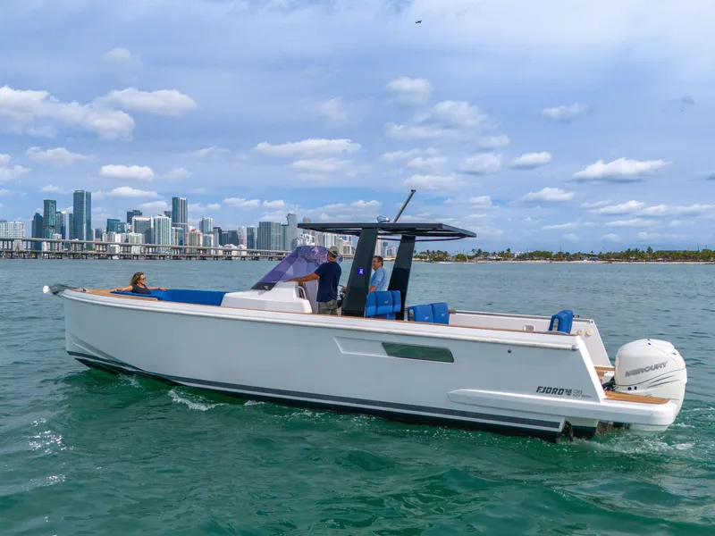 Slide: The Image of 2019 Fjord 38 Xpress boat cruising near city skyline on a sunny day. - 11