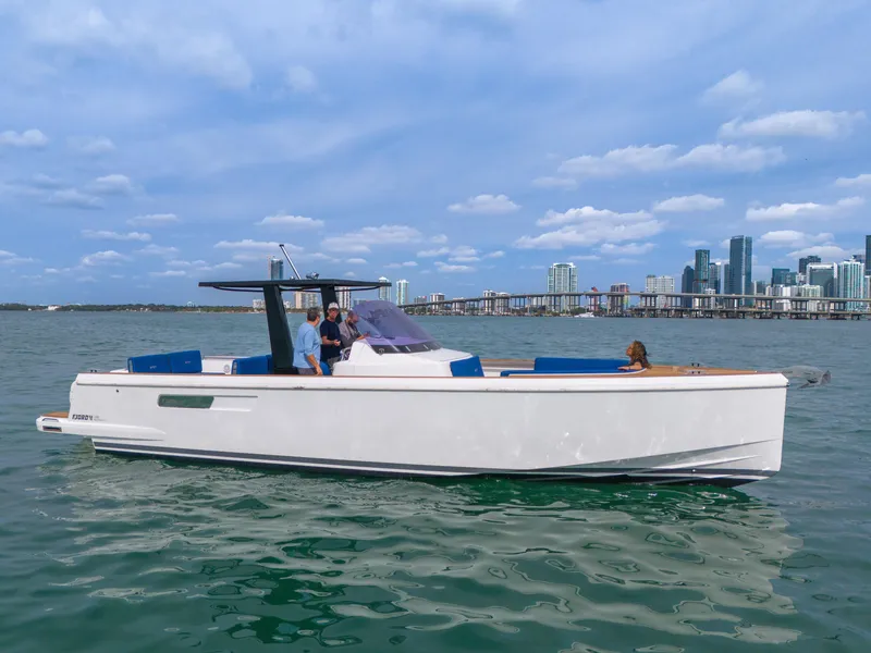Slide: The Image of 2019 Fjord 38 Xpress boat cruising near city skyline under blue sky. - 13