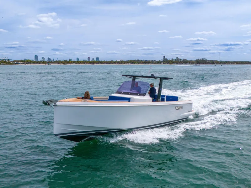 Slide: The Image of 2019 Fjord 38 Xpress cruising on open water with city skyline in background. - 33