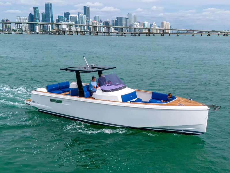 Slide: The Image of 2019 Fjord 38 Xpress cruising in coastal waters with city skyline backdrop. - 37
