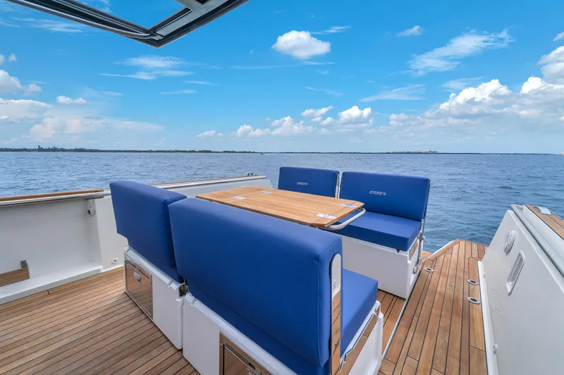 Slide: The Image of 2019 Fjord 38 Xpress yacht deck with blue seating and ocean view. - 42