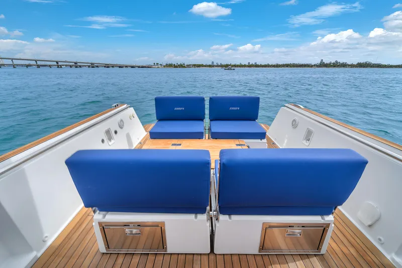 Slide: The Image of 2019 Fjord 38 Xpress boat with blue seating, wooden deck, and ocean view. - 47