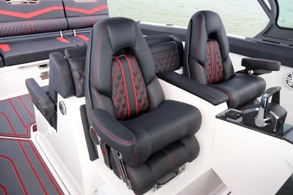 Slide: The Image of Luxury seating on 2025 Monterey Elite 30 OB boat with black and red accents. - 15