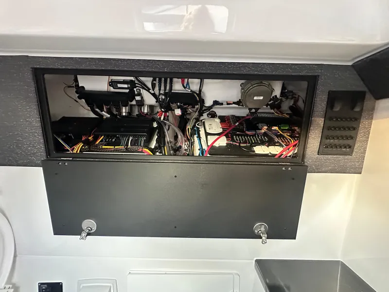 Slide: The Image of 2025 Monterey Elite 30 OB electrical panel with wiring and components exposed. - 20