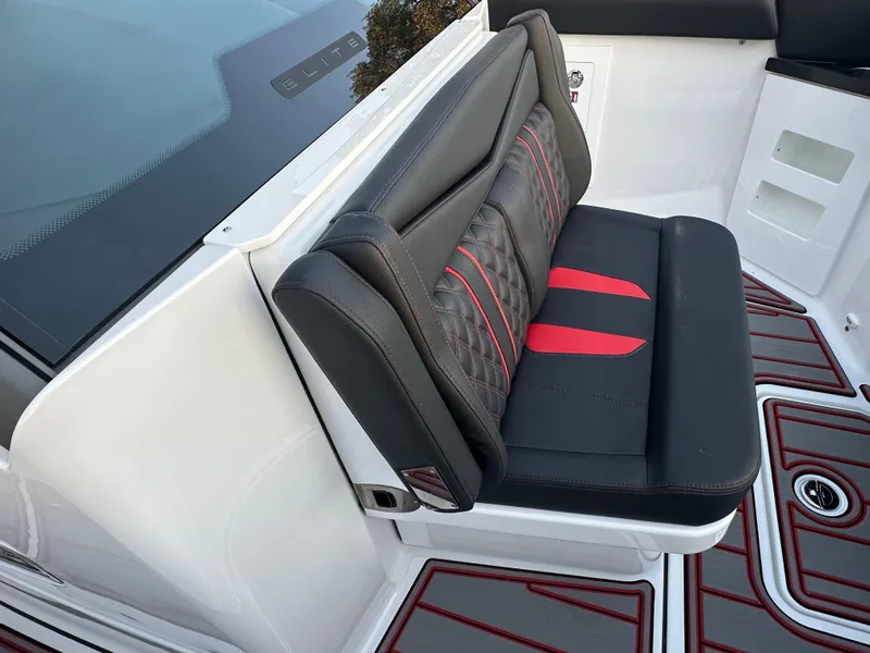 Slide: The Image of Luxurious seating on 2025 Monterey Elite 30 OB boat with red and black accents. - 25