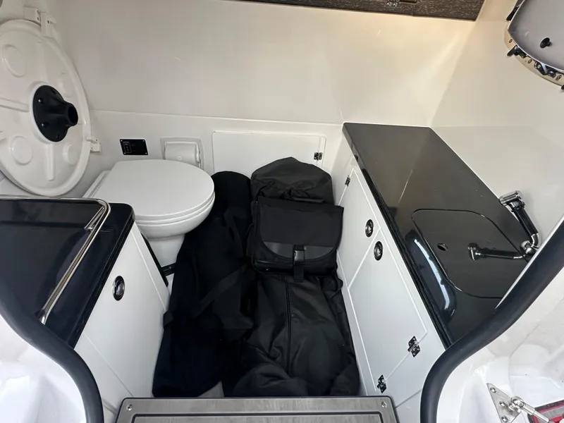 Slide: The Image of Interior of 2025 Monterey Elite 30 OB boat with toilet and sink. - 27