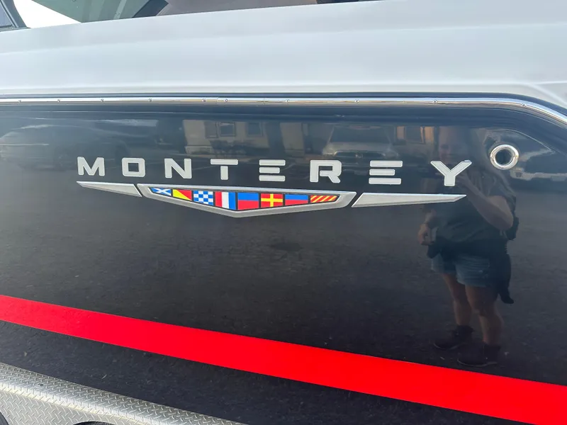 Slide: The Image of 2025 Monterey Elite 30 OB boat logo with nautical flags and red stripe. - 3