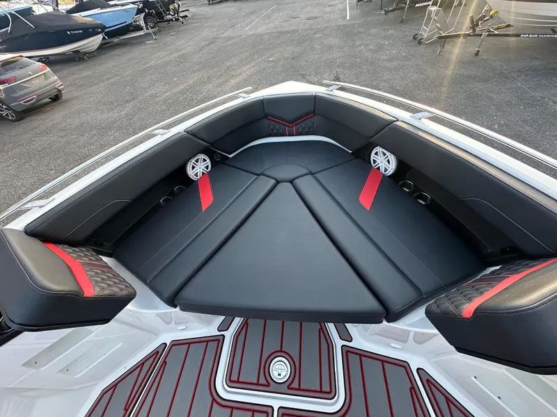 Slide: The Image of 2025 Monterey Elite 30 OB boat interior with black and red seating, speakers, and sleek design. - 38
