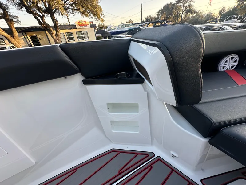 Slide: The Image of Interior of 2025 Monterey Elite 30 OB boat with black seating and red accents. - 40
