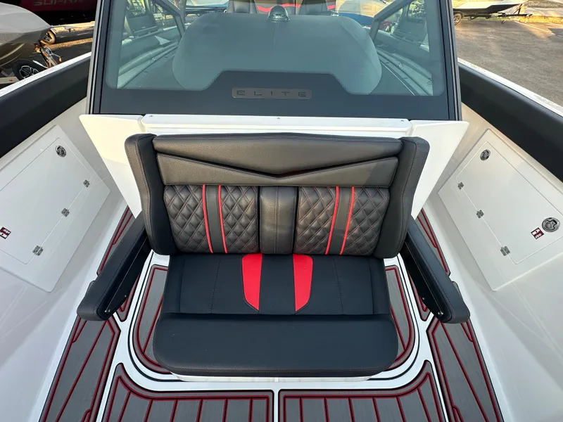 Slide: The Image of 2025 Monterey Elite 30 OB boat interior with black and red seating and stylish design. - 43