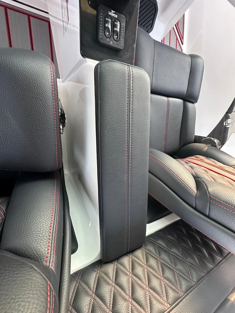 Slide: The Image of 2025 Monterey Elite 30 OB interior with black leather seats and red stitching. - 48